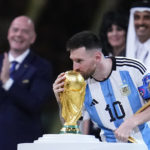 
              Argentina's Lionel Messi kisses the World Cup trophy after receiving the Golden Ball award for best player of the tournament during the awards ceremony after Argentina defeated France in the World Cup final soccer match at the Lusail Stadium in Lusail, Qatar, Sunday, Dec. 18, 2022. (AP Photo/Natacha Pisarenko)
            
