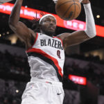 
              Portland Trail Blazers' Jerami Grant dunks during the first half of an NBA basketball game against the San Antonio Spurs, Wednesday, Dec. 14, 2022, in San Antonio. (AP Photo/Darren Abate)
            