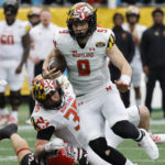 
              Maryland quarterback Billy Edwards Jr. carries the ball against North Carolina State during the first half of the Duke's Mayo Bowl NCAA college football game in Charlotte, N.C., Friday, Dec. 30, 2022. (AP Photo/Nell Redmond)
            