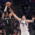 
              Houston Rockets forward Jabari Smith Jr. (1) shoots against Dallas Mavericks guard Luka Doncic (77) during the first quarter of an NBA basketball game in Dallas, Thursday, Dec. 29, 2022. (AP Photo/LM Otero)
            