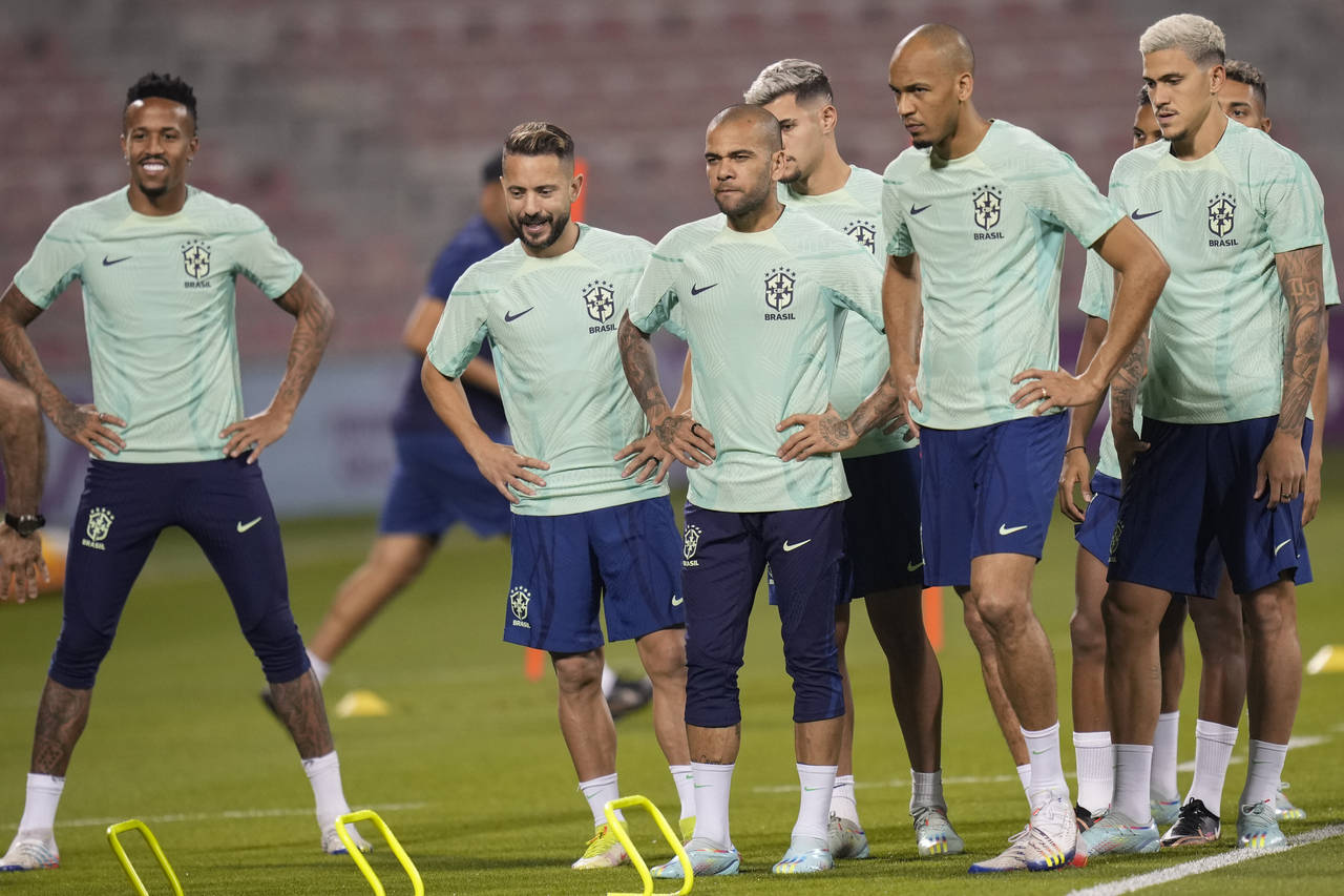 Brazil's Dani Alves, center, and teammates exercise during a training session at the Grand Hamad st...