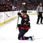 
              Ottawa Senators left wing Tim Stutzle slides on the ice as he celebrates his goal against the Boston Bruins during the second period of an NHL hockey game in Ottawa, Ontario, on Tuesday, Dec. 27, 2022. (Justin Tang/The Canadian Press via AP)
            