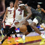 
              Minnesota Timberwolves forward Jaden McDaniels, right, drives to the basket as Miami Heat guard Max Strus (31) defends during the first half of an NBA basketball game, Monday, Dec. 26, 2022, in Miami. (AP Photo/Lynne Sladky)
            