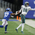 
              Philadelphia Eagles wide receiver Quez Watkins (16) reaches for a pass against New York Giants cornerback Fabian Moreau (37) during the second quarter of an NFL football game, Sunday, Dec. 11, 2022, in East Rutherford, N.J. (AP Photo/John Minchillo)
            