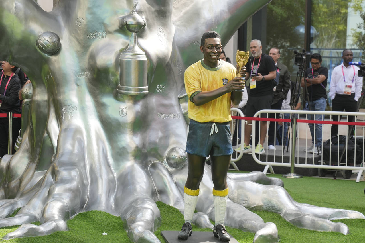 A life-size statue of Brazilian soccer legend Pele is displayed during an Conmebol event to pay tri...