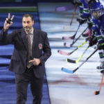 
              Former Vancouver Canucks goalie Roberto Luongo waves as he walks onto the ice to be honored with other Hockey Hall of Fame inductees, Daniel and Henrik Sedin, before an NHL hockey game between the Canucks and the Florida Panthers on Thursday, Dec. 1, 2022, in Vancouver, British Columbia. (Darryl Dyck/The Canadian Press via AP)
            