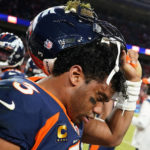 
              Denver Broncos quarterback Russell Wilson (3) removes his helmet after a concussion against the Kansas City Chiefs during the second half of an NFL football game, Sunday, Dec. 11, 2022, in Denver. (AP Photo/Jack Dempsey)
            