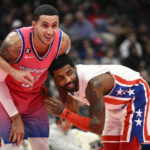
              Washington Wizards forward Kyle Kuzma (33) and Brooklyn Nets guard Kyrie Irving, right, react during a foul shot in the first half of an NBA basketball game, Monday, Dec. 12, 2022, in Washington. (AP Photo/Nick Wass)
            
