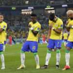 
              Brazil's Vinicius Junior, 2nd left, celebrates after scoring his side's opening goal during the World Cup round of 16 soccer match between Brazil and South Korea at the Stadium 974 in Doha, Qatar, Monday, Dec. 5, 2022. Left to right, Raphinha, Vinicius Junior, Lucas Paqueta, Neymar. (AP Photo/Jin-Man Lee)
            
