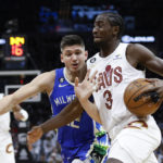 
              Cleveland Cavaliers guard Caris LeVert (3) drives against Milwaukee Bucks guard Grayson Allen (12) during the second half of an NBA basketball game Wednesday, Dec. 21, 2022, in Cleveland. (AP Photo/Ron Schwane)
            