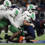 
              UTSA running back Kevorian Barnes, right, is stopped by North Texas linebacker Larry Nixon III (3) on a run during the second half of an NCAA college football game for the Conference USA championship in San Antonio, Friday, Dec. 2, 2022. (AP Photo/Eric Gay)
            