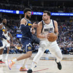 
              Dallas Mavericks guard Luka Doncic, right, is defended by Denver Nuggets guard Jamal Murray during the first half of an NBA basketball game Tuesday, Dec. 6, 2022, in Denver. (AP Photo/David Zalubowski)
            
