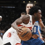 
              Toronto Raptors forward O.G. Anunoby drives past Orlando Magic's Cole Anthony during the first half of an NBA basketball game, Saturday, Dec. 3, 2022 in Toronto. (Chris Young/The Canadian Press via AP)
            