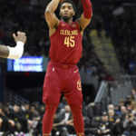 
              Cleveland Cavaliers guard Donovan Mitchell shoots a 3-point basket during the second half of an NBA basketball game against the Utah Jazz, Monday, Dec. 19, 2022, in Cleveland. (AP Photo/Nick Cammett)
            