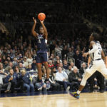 
              Connecticut guard Nahiem Alleyne (4) shoots in front of Butler guard Chuck Harris (3) in the second half of an NCAA college basketball game in Indianapolis, Saturday, Dec. 17, 2022. (AP Photo/AJ Mast)
            