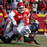 
              Seattle Seahawks quarterback Geno Smith (7) is sacked by Kansas City Chiefs defensive end George Karlaftis (56) as defensive tackle Chris Jones (95) gets in on the play during the first half of an NFL football game Saturday, Dec. 24, 2022, in Kansas City, Mo. (AP Photo/Ed Zurga)
            
