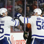 
              Toronto Maple Leafs center Alexander Kerfoot (15) celebrates after his goal against the Arizona Coyotes with Maple Leafs left wing Michael Bunting (58) during the second period of an NHL hockey game in Tempe, Ariz., Thursday, Dec. 29, 2022. (AP Photo/Ross D. Franklin)
            