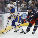 
              Buffalo Sabres' Rasmus Dahlin, left, and Columbus Blue Jackets' Yegor Chinakhov fight for a loose puck during the second period of an NHL hockey game on Wednesday, Dec. 7, 2022, in Columbus, Ohio. (AP Photo/Jay LaPrete)
            