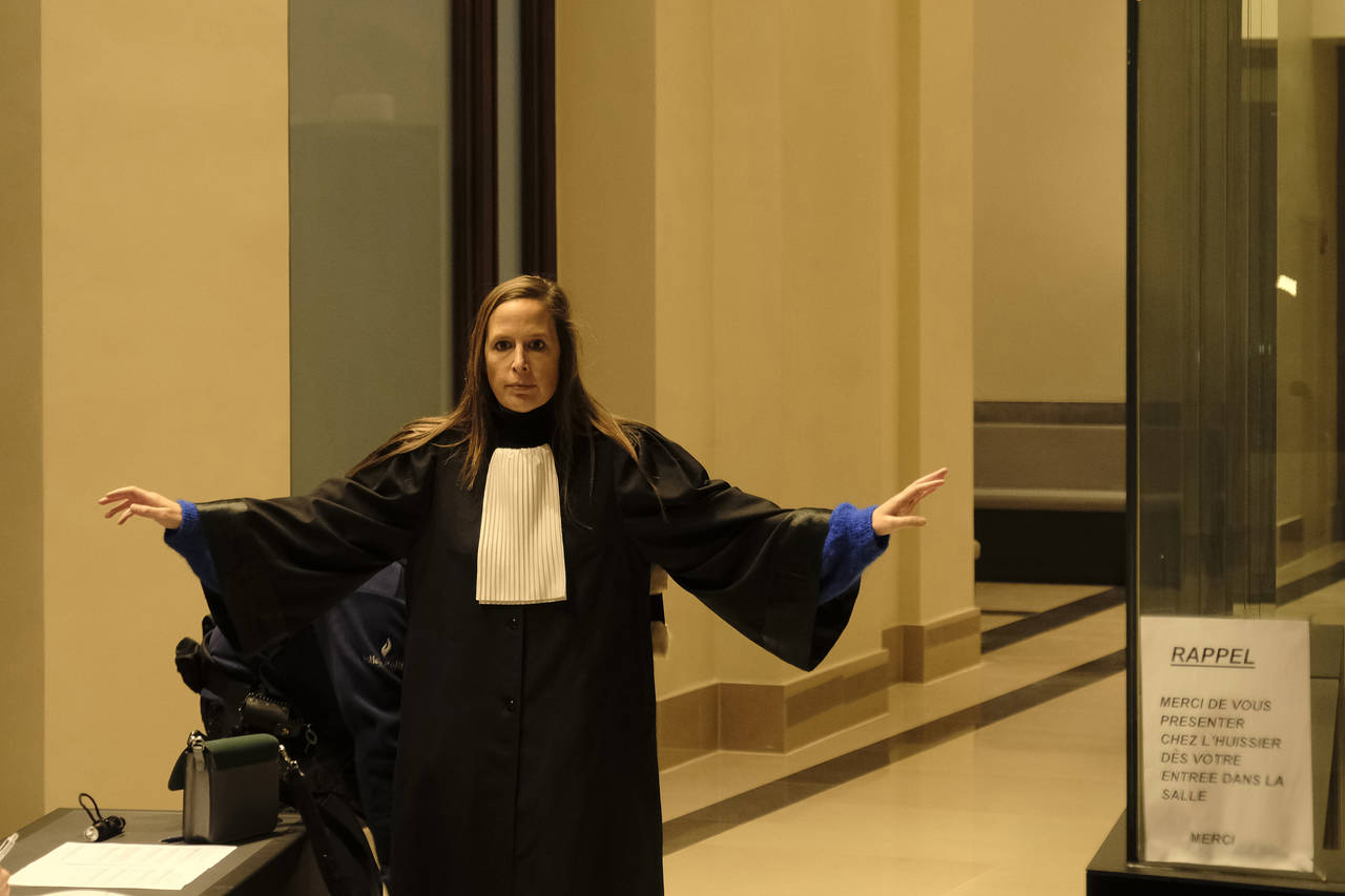 Lawyer Barbara Huylebroeck is searched at security as she enters the Justice Palace during a pre-tr...