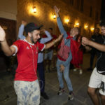 
              Moroccan soccer fans dance at the Souq Waqif during the FIFA World Cup, in Doha, Qatar on Sunday Dec. 4, 2022. (AP Photo/Ashley Landis)
            