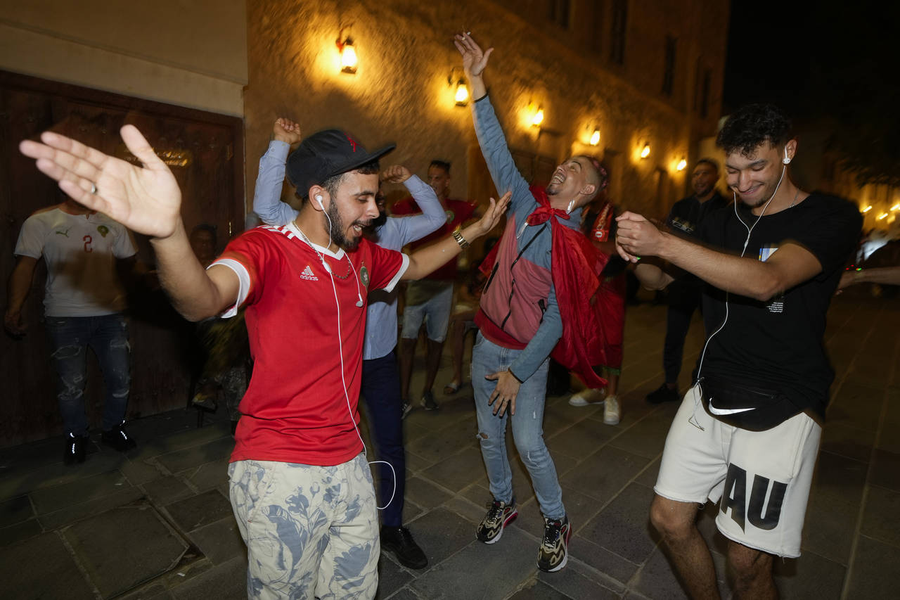Moroccan soccer fans dance at the Souq Waqif during the FIFA World Cup, in Doha, Qatar on Sunday De...