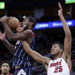
              Houston Rockets forward Tari Eason, left, pulls down a rebound as Miami Heat center Orlando Robinson (25) tangles up with him during the first half of an NBA basketball game Thursday, Dec. 15, 2022, in Houston. (AP Photo/Michael Wyke)
            