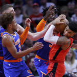 
              Houston Rockets forward Kenyon Martin Jr., right, wrestles the ball away as, from left to right, New York Knicks' Isaiah Hartenstein, Miles McBride and Julius Randle reach in during the first half of an NBA basketball game Saturday, Dec. 31, 2022, in Houston. (AP Photo/Michael Wyke)
            