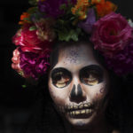 
              A woman dressed as a "Catrina", poses for tourists in Mexico City's main square, the Zocalo, as part of the Day of the Dead festivities, on Oct. 28, 2022.  (AP Photo/Marco Ugarte)
            