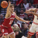 
              Arizona guard Kerr Kriisa (25) passes the ball around Indiana forward Miller Kopp (12) during the first half of an NCAA college basketball game Saturday, Dec. 10, 2022, in Las Vegas. (AP Photo/Chase Stevens)
            