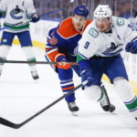 
              Vancouver Canucks forward J.T. Miller, right, and Edmonton Oilers forward Zach Hyman follow the play during first-period NHL hockey game action in Edmonton, Alberta, Friday, Dec. 23, 2022. (Jeff McIntosh/The Canadian Press via AP)
            