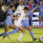 
              Florida State's Olivia Garcia (0) works between North Carolina's Emerson Elgin (6) and Aleigh Gambone, right for a ball during the first half of an NCAA women's soccer tournament semifinal in Cary, N.C., Friday, Dec. 2, 2022. (AP Photo/Ben McKeown)
            