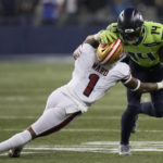 
              Seattle Seahawks wide receiver DK Metcalf (14) runs against San Francisco 49ers cornerback Jimmie Ward (1) during the second half of an NFL football game in Seattle, Thursday, Dec. 15, 2022. (AP Photo/Stephen Brashear)
            
