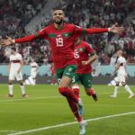 
              Morocco's Youssef En-Nesyri celebrates after scoring his side's first goal during the World Cup quarterfinal soccer match between Morocco and Portugal, at Al Thumama Stadium in Doha, Qatar, Saturday, Dec. 10, 2022. (AP Photo/Martin Meissner)
            