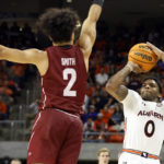 
              Auburn guard K.D. Johnson (0) shoots as Colgate guard Braeden Smith (2) defends during the second half of an NCAA college basketball game Friday, Dec. 2, 2022, in Auburn, Ala. (AP Photo/Butch Dill)
            