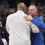 
              Denver Nuggets head coach Michael Malone, right, greets Washington Wizards head coach Wes Unseld Jr. during an NBA basketball game Wednesday, Dec. 14, 2022, in Denver. Unseld served as an assistant coach for Malone in Denver. (AP Photo/David Zalubowski)
            