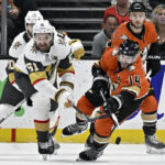 
              Anaheim Ducks center Adam Henrique, right, clears the puck away from Vegas Golden Knights right wing Mark Stone, left, during the first period of an NHL hockey game in Anaheim, Calif., Wednesday, Dec. 28, 2022. (AP Photo/Alex Gallardo)
            