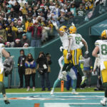 
              Green Bay Packers tight end Marcedes Lewis (89) celebrates with teammate Green Bay Packers tight end Josiah Deguara (81), after scoring a touchdown during the first half of an NFL football game against the Miami Dolphins, Sunday, Dec. 25, 2022, in Miami Gardens, Fla. (AP Photo/Jim Rassol)
            