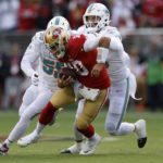 
              San Francisco 49ers quarterback Jimmy Garoppolo, middle, scrambles before being sacked by Miami Dolphins linebacker Jerome Baker, left, and linebacker Jaelan Phillips during the first half of an NFL football game in Santa Clara, Calif., Sunday, Dec. 4, 2022. (AP Photo/Jed Jacobsohn)
            