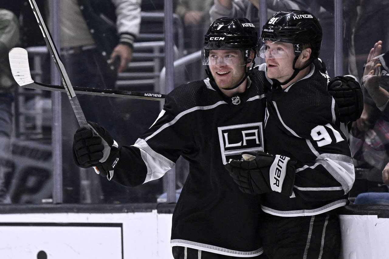 Los Angeles Kings right wing Carl Grundstrom, right, celebrates his goal against the Arizona Coyote...