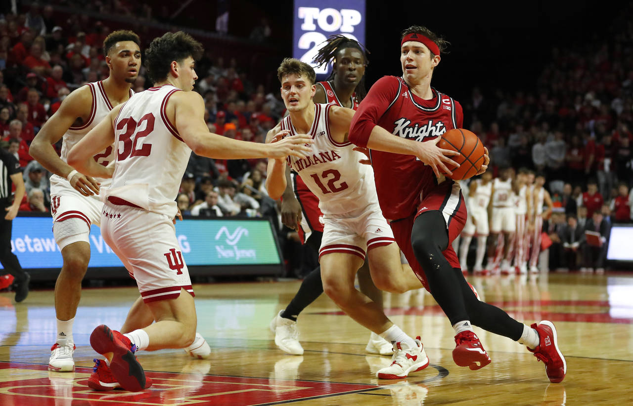Rutgers guard Paul Mulcahy, right, drives to the basket against Indiana forward Miller Kopp (12) an...