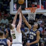 
              Denver Nuggets center Nikola Jokic (15) makes a basket while being fouled by New Orleans Pelicans guard Trey Murphy III (25) in the first half of an NBA basketball game in New Orleans, Sunday, Dec. 4, 2022. (AP Photo/Matthew Hinton)
            
