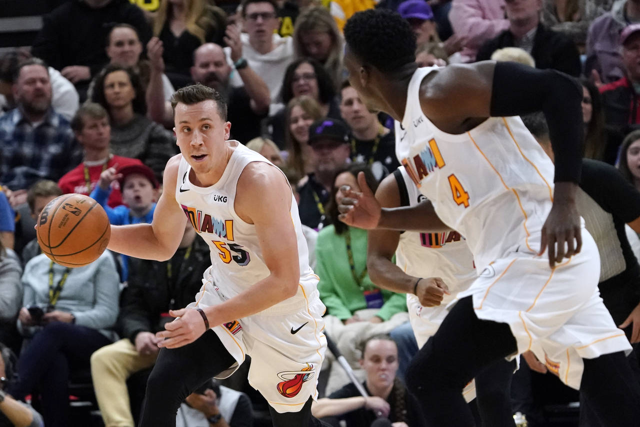 Miami Heat forward Duncan Robinson (55) looks to pass the ball to guard Victor Oladipo (4) during t...