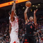 
              Toronto Raptors forward Scottie Barnes (4) shoots over Brooklyn Nets center Nic Claxton (33) during the first half of an NBA basketball game in Toronto, Friday, Dec. 16, 2022. (Cole Burston/The Canadian Press via AP)
            