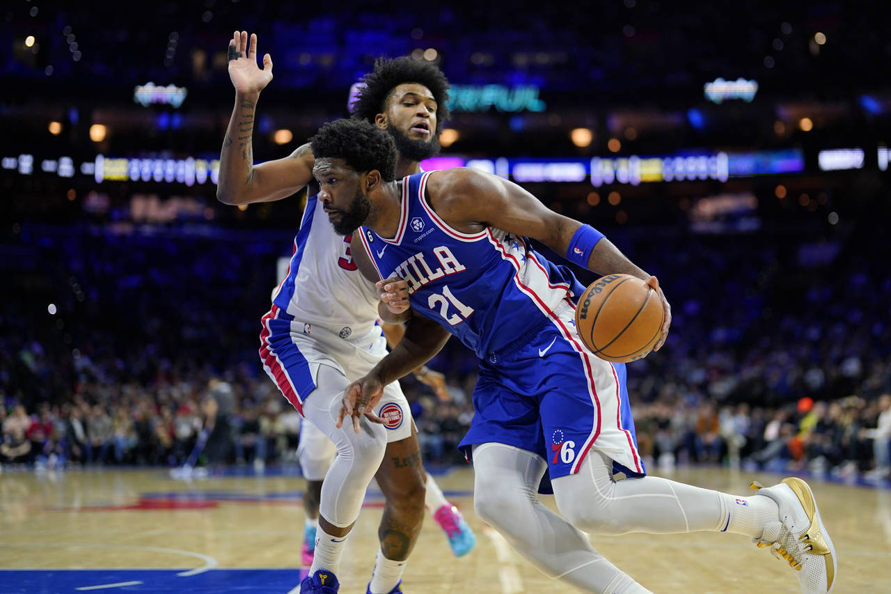 Philadelphia 76ers' Joel Embiid, right, tries to get past Detroit Pistons' Marvin Bagley III during...