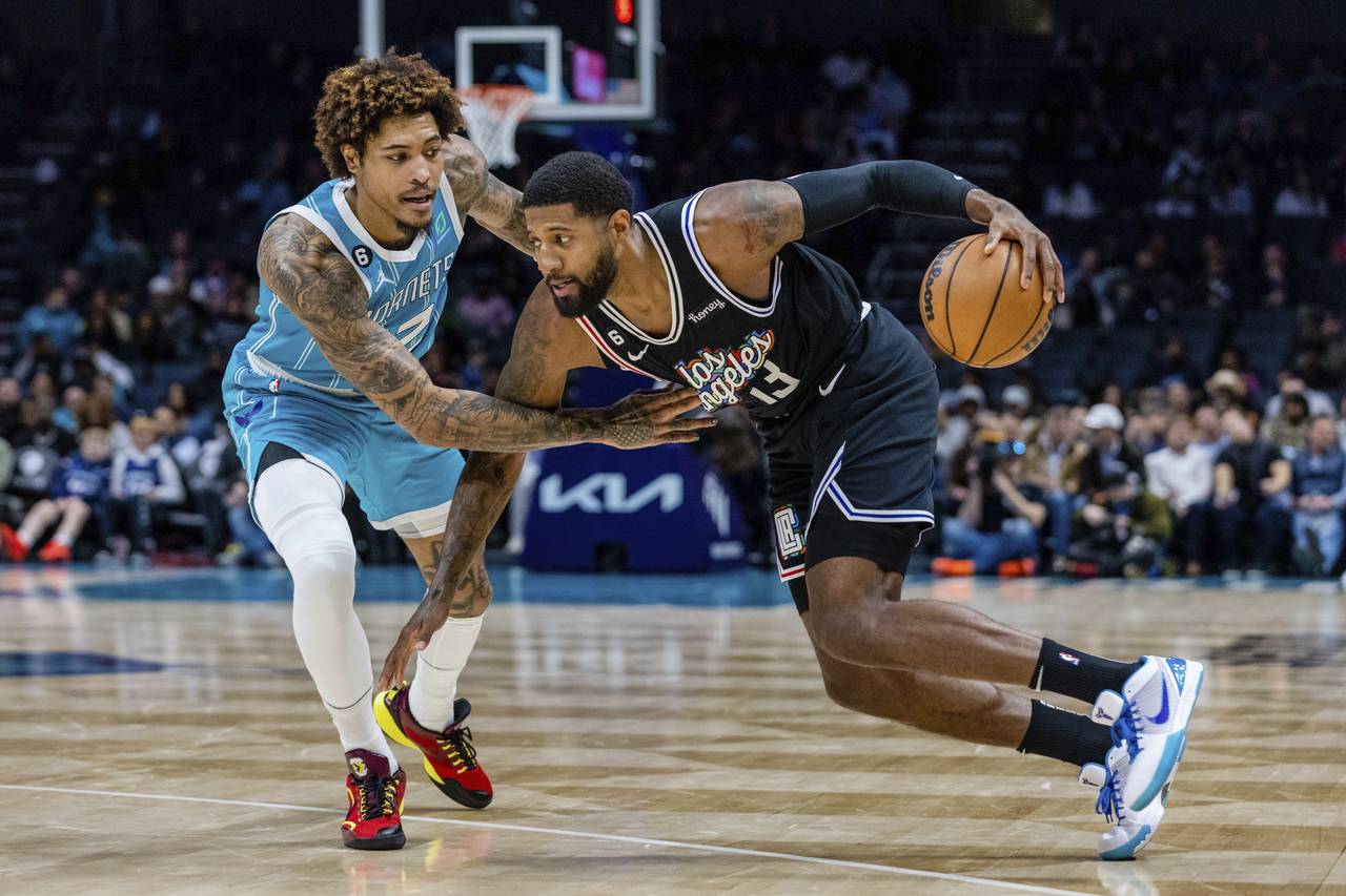 Charlotte Hornets guard Kelly Oubre Jr. guards LA Clippers guard Paul George (13) as he drives with...