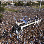 
              The Argentine soccer team that won the World Cup title ride on an open bus during their homecoming parade in Buenos Aires, Argentina, Tuesday, Dec. 20, 2022. (AP Photo/Rodrigo Abd)
            