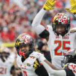 
              Maryland defensive back Beau Brade (25) celebrates with linebacker Fa'Najae Gotay, left, after Gotay intercepted a North Carolina State pass during the first half of the Duke's Mayo Bowl NCAA college football game in Charlotte, N.C., Friday, Dec. 30, 2022. (AP Photo/Nell Redmond)
            