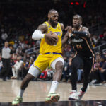 
              Los Angeles Lakers forward LeBron James drives to the basket against Atlanta Hawks forward AJ Griffin during the first half of an NBA basketball game Friday, Dec. 30, 2022, in Atlanta. (AP Photo/Hakim Wright Sr.)
            