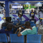 
              A man plays a world cup betting game at a sports betting shop in Lagos, Nigeria, Monday, Dec. 5, 2022. Although sports betting is a global phenomenon and a legitimate business in many countries, the stakes are high on the continent of 1.3 billion people because of lax or non-existent regulation, poverty and widespread unemployment. (AP Photo/Sunday Alamba)
            