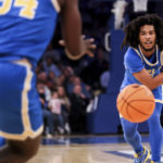 
              UCLA guard Tyger Campbell passes the ball during the first half of an NCAA college basketball game against Kentucky in the CBS Sports Classic, Saturday, Dec. 17, 2022, in New York. (AP Photo/Julia Nikhinson)
            